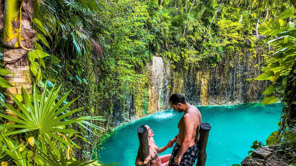 A sculpture installation beside the open cenote at ATIK jungle art park on a Tulum cenote tour